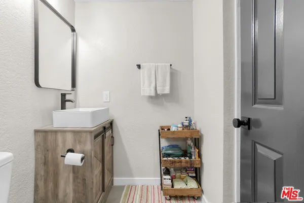 a view of a hallway with a livingroom and a couch