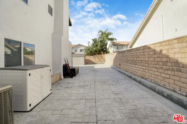 a view of a house with sitting area and roof with furniture