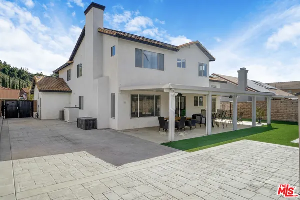 a terrace of a house with outdoor seating
