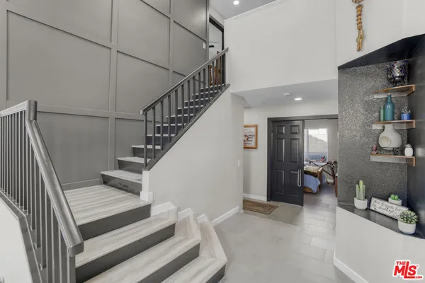 a spacious bathroom with double vanity a mirror and a shower