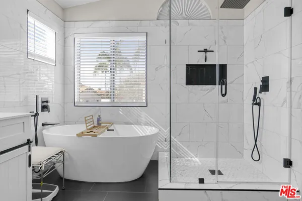 a bathroom with a double vanity sink toilet mirror and shower