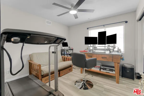 a bedroom with a bed and a desk