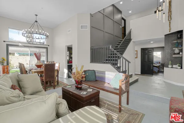 a living room with furniture a chandelier and a chandelier