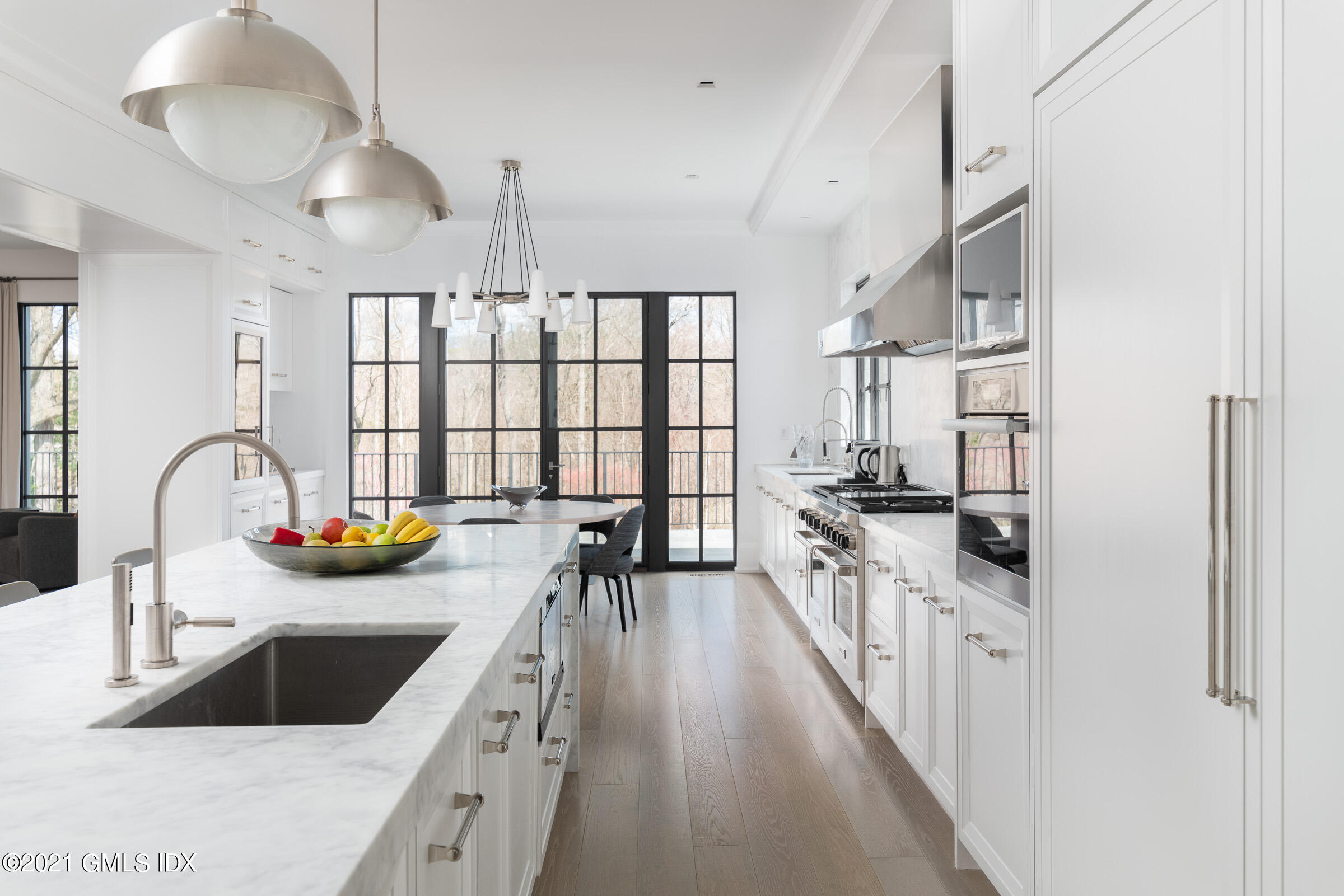 425 North Maple Avenue Greenwich, CT 06830 - Photo 11 of 30 a kitchen with stainless steel appliances a sink a stove and a wooden floors