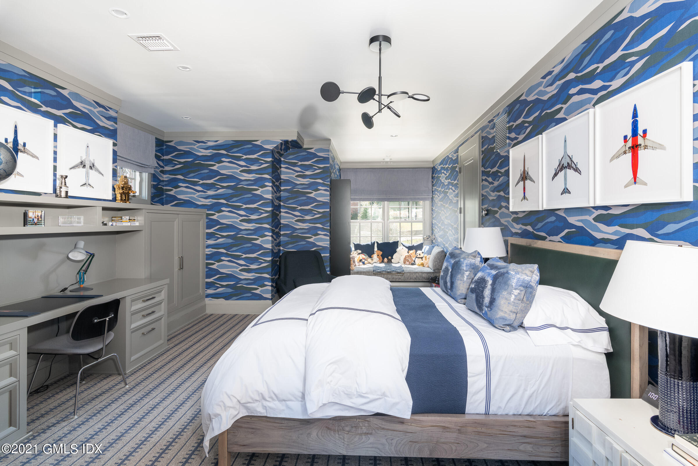 425 North Maple Avenue Greenwich, CT 06830 - Photo 18 of 30 a large bedroom with a bed and dresser with wooden floor