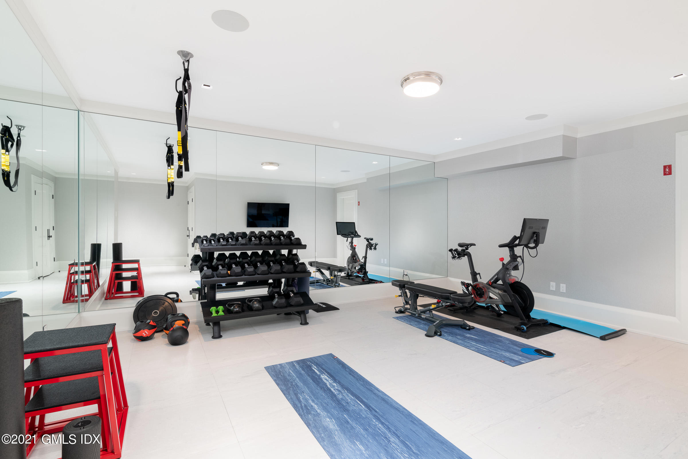 425 North Maple Avenue Greenwich, CT 06830 - Photo 23 of 30 a room with gym equipment and a view of living room