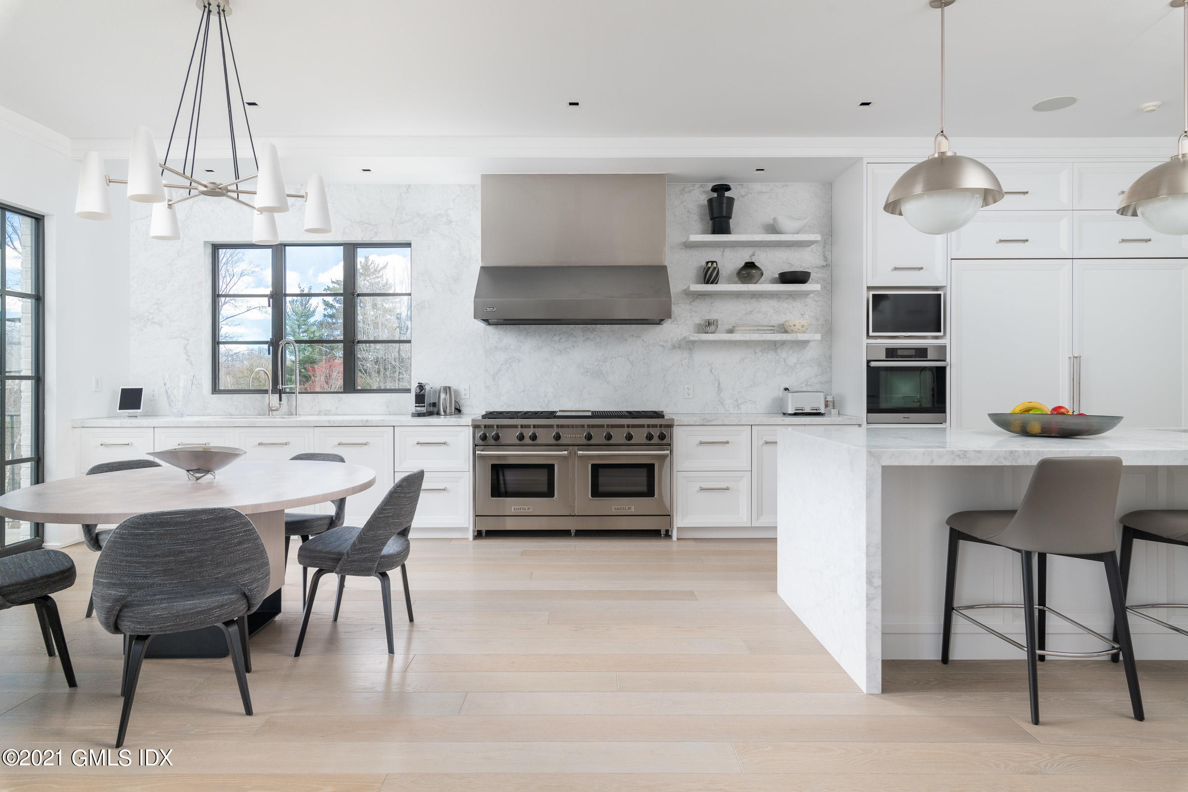 425 North Maple Avenue Greenwich, CT 06830 - Photo 9 of 30 a kitchen with stainless steel appliances a stove a table and chairs in it