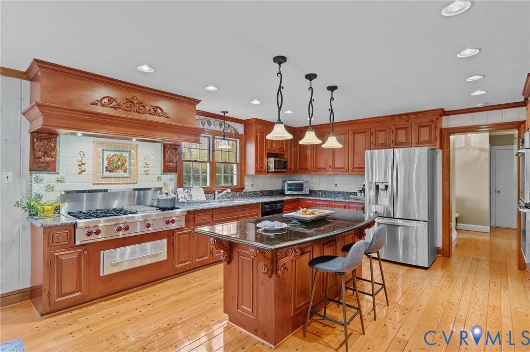1517 Old Church Road Mechanicsville, VA 23111 - Photo 15 of 50 Kitchen with brown cabinets, dark stone counters,