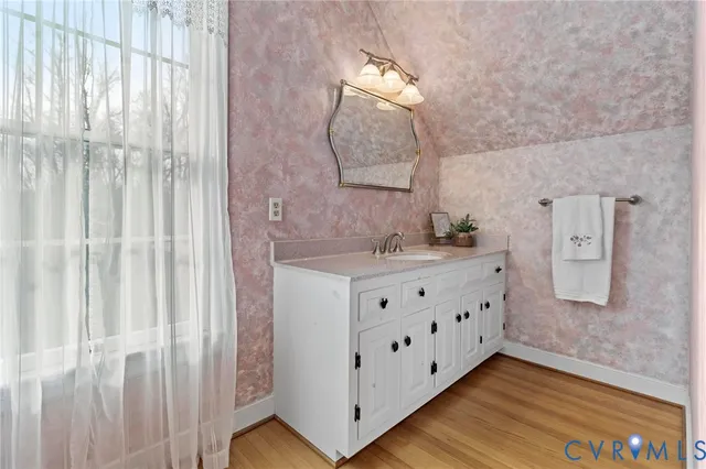 a bathroom with a double vanity sink and a mirror
