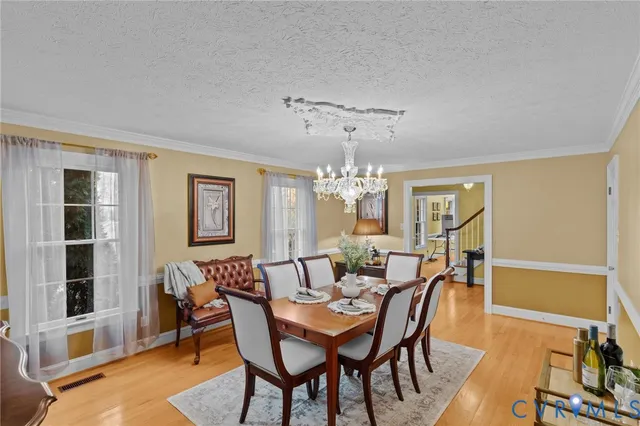 a view of a dining room with furniture and chandelier
