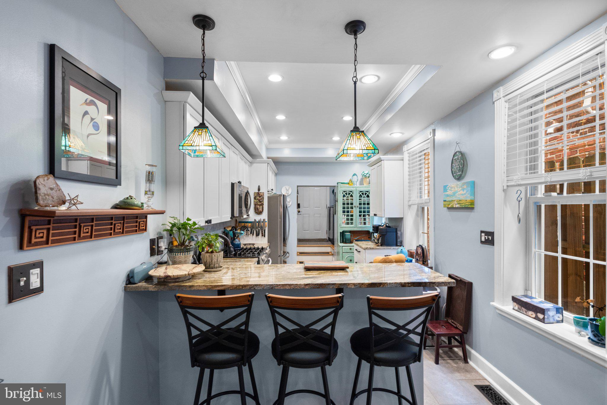 3228 Fait Avenue Baltimore, MD 21224 - Photo 12 of 44 a dining room with stainless steel appliances kitchen island a table and chairs