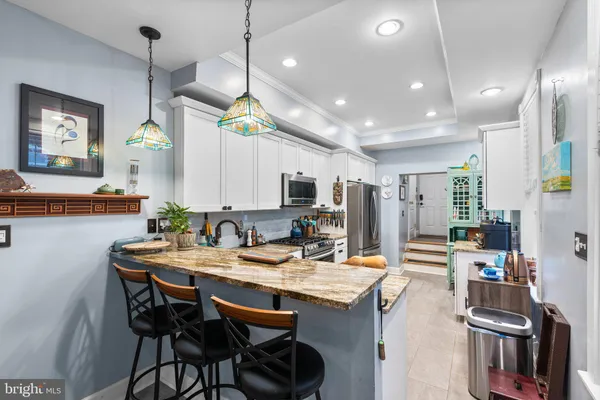 a kitchen with a table and chairs in it