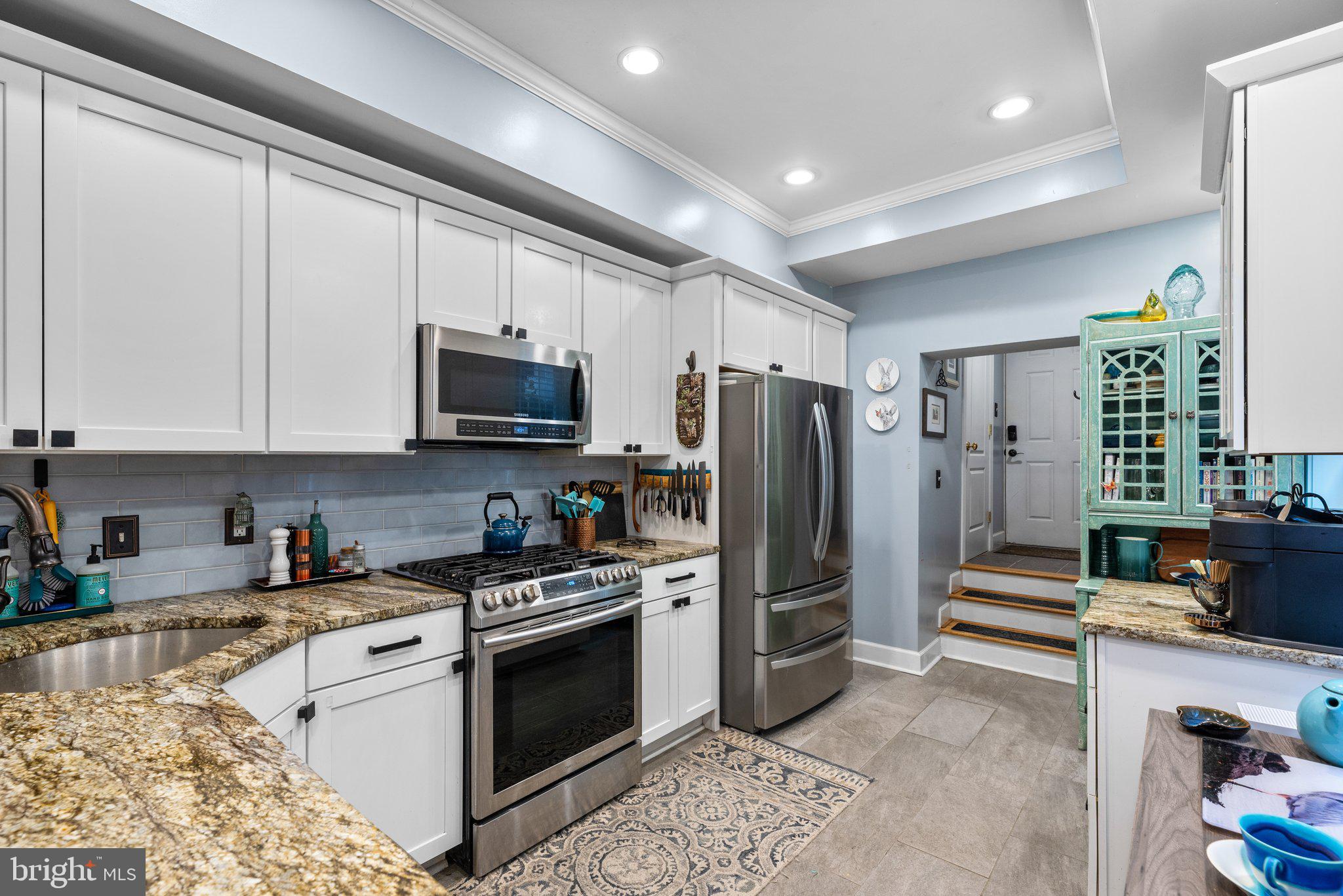 3228 Fait Avenue Baltimore, MD 21224 - Photo 14 of 44 a kitchen with stainless steel appliances granite countertop a stove a refrigerator and a microwave