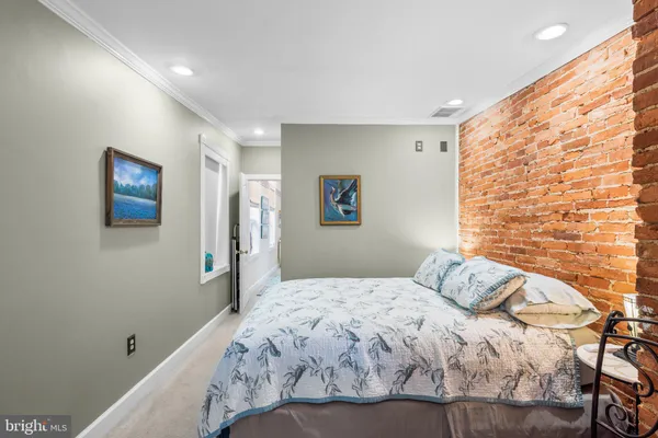 a bedroom with a bed and a painting