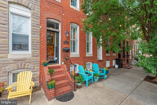 a view of a patio with chairs and potted plants