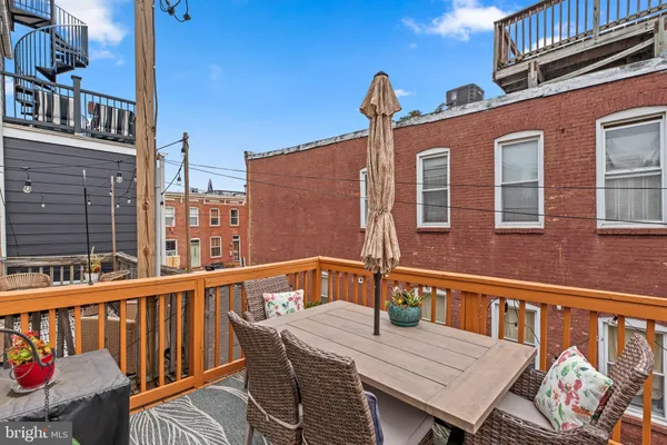 a view of a deck with a table and chairs with wooden floor