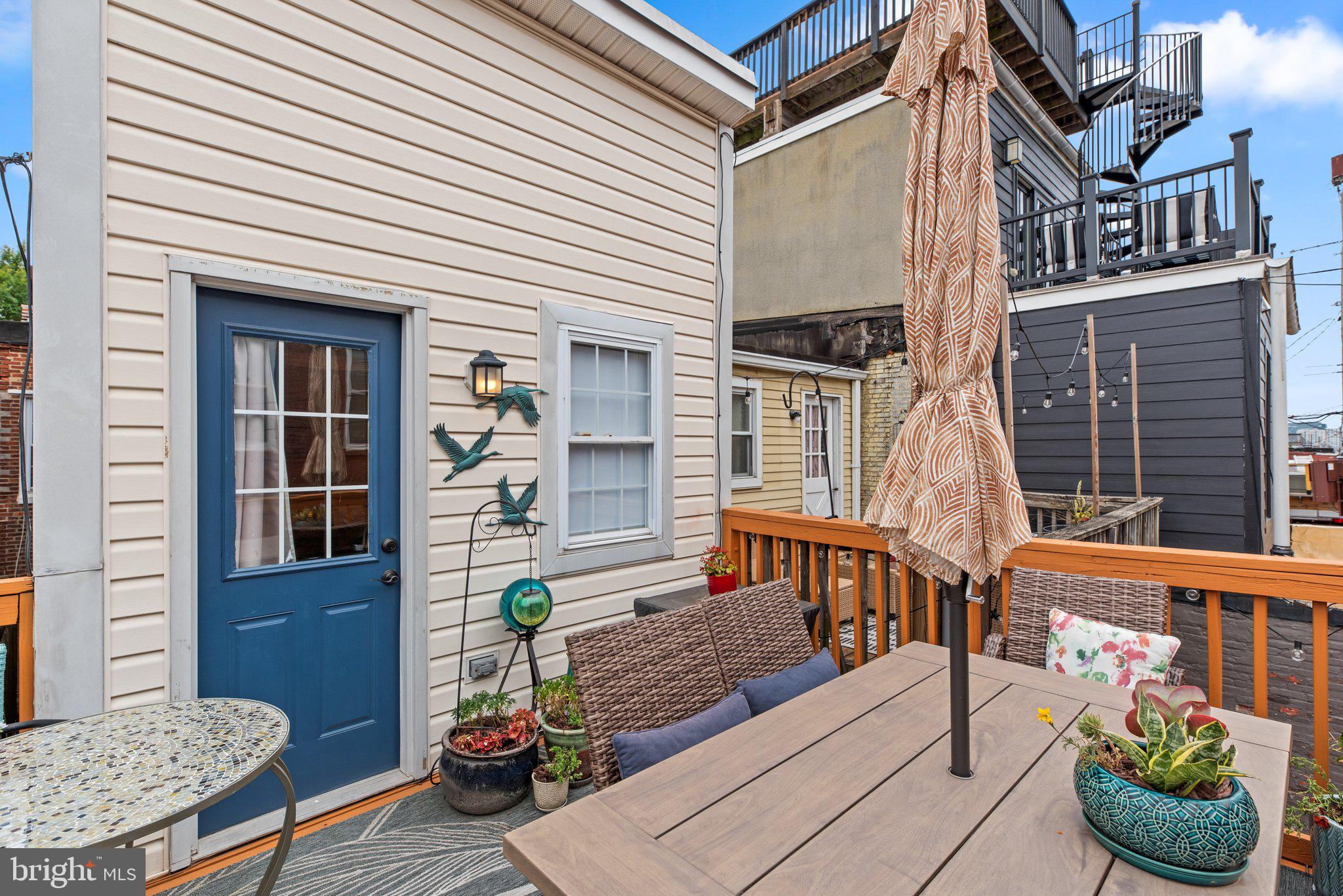 3228 Fait Avenue Baltimore, MD 21224 - Photo 36 of 44 a view of a deck with couches table and chairs and potted plants