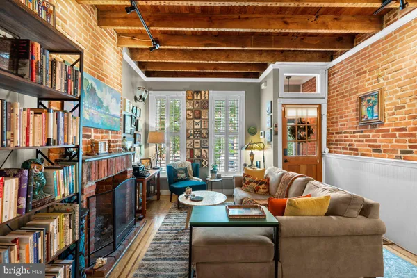 a living room with furniture a bookshelf and a large window