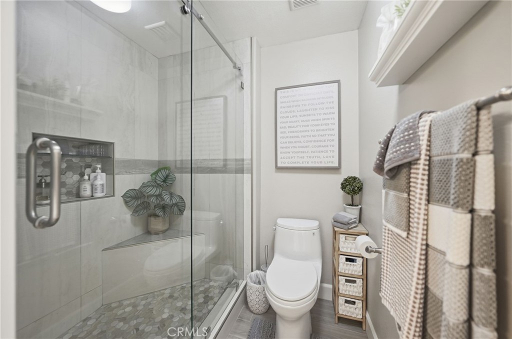 33433 Emerson Way, Unit A Temecula, CA 92592 - Photo 14 of 31 a bathroom with a toilet sink and shower