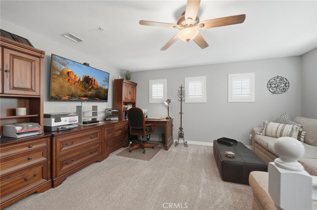 33433 Emerson Way, Unit A Temecula, CA 92592 - Photo 18 of 31 a living room with furniture and a flat screen tv