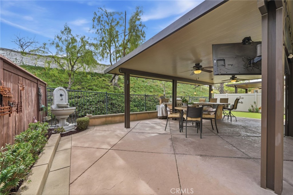33433 Emerson Way, Unit A Temecula, CA 92592 - Photo 21 of 31 a view of a patio with a table and chairs under an umbrella