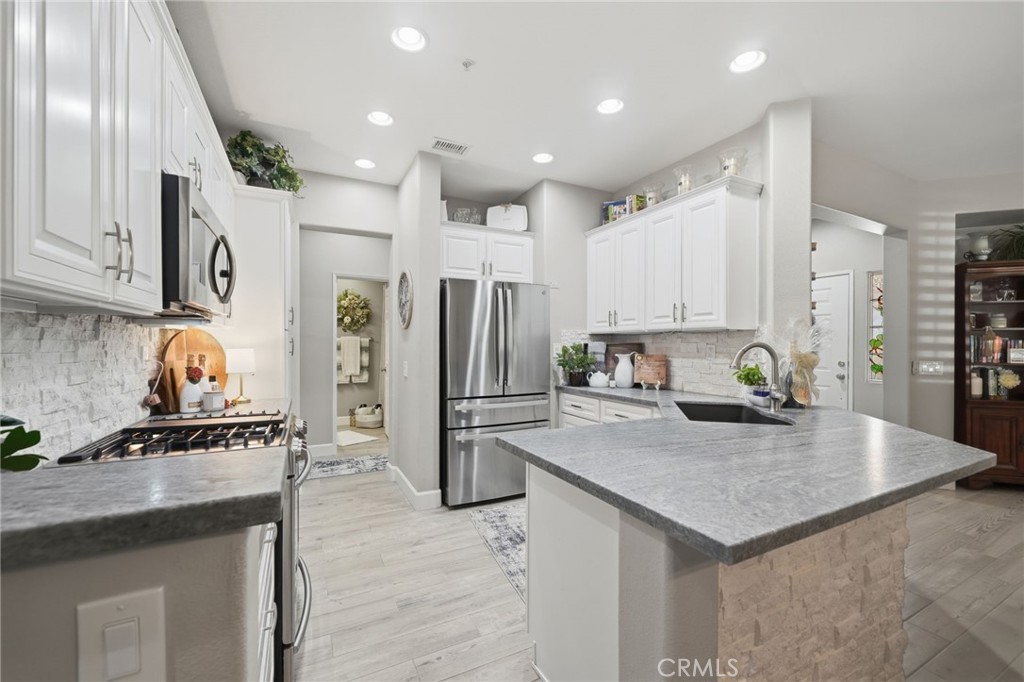 33433 Emerson Way, Unit A Temecula, CA 92592 - Photo 8 of 31 a kitchen with a refrigerator a sink and a stove