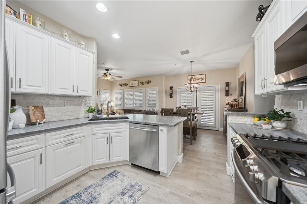 33433 Emerson Way, Unit A Temecula, CA 92592 - Photo 10 of 31 a kitchen with stove a sink and cabinets