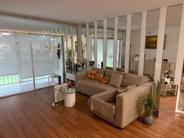 a living room with furniture and a potted plant