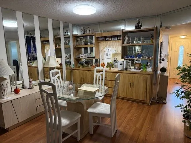 a view of a dining room with furniture and wooden floor