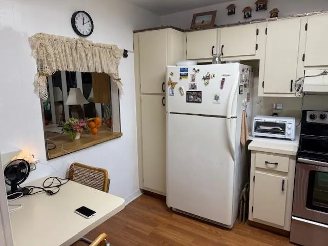 a white refrigerator freezer sitting inside of a kitchen