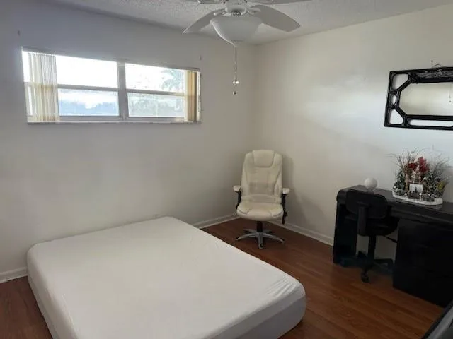 a bedroom with a bed and a desk