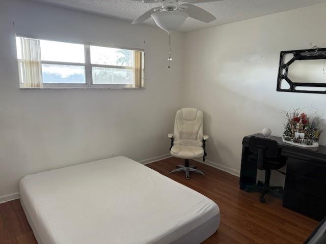 8990 South Hollybrook Boulevard, Unit 302 Pembroke Pines, FL 33025 - Photo 9 of 13 a bedroom with a bed and a desk