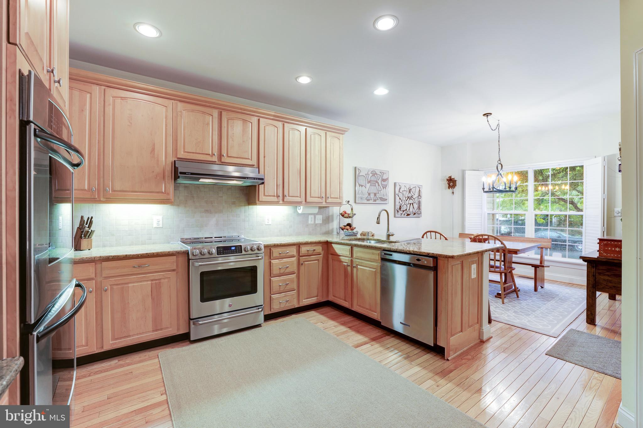 20135 Valhalla Square Ashburn, VA 20147 - Photo 11 of 41 a kitchen with stainless steel appliances granite countertop a stove a sink and a refrigerator