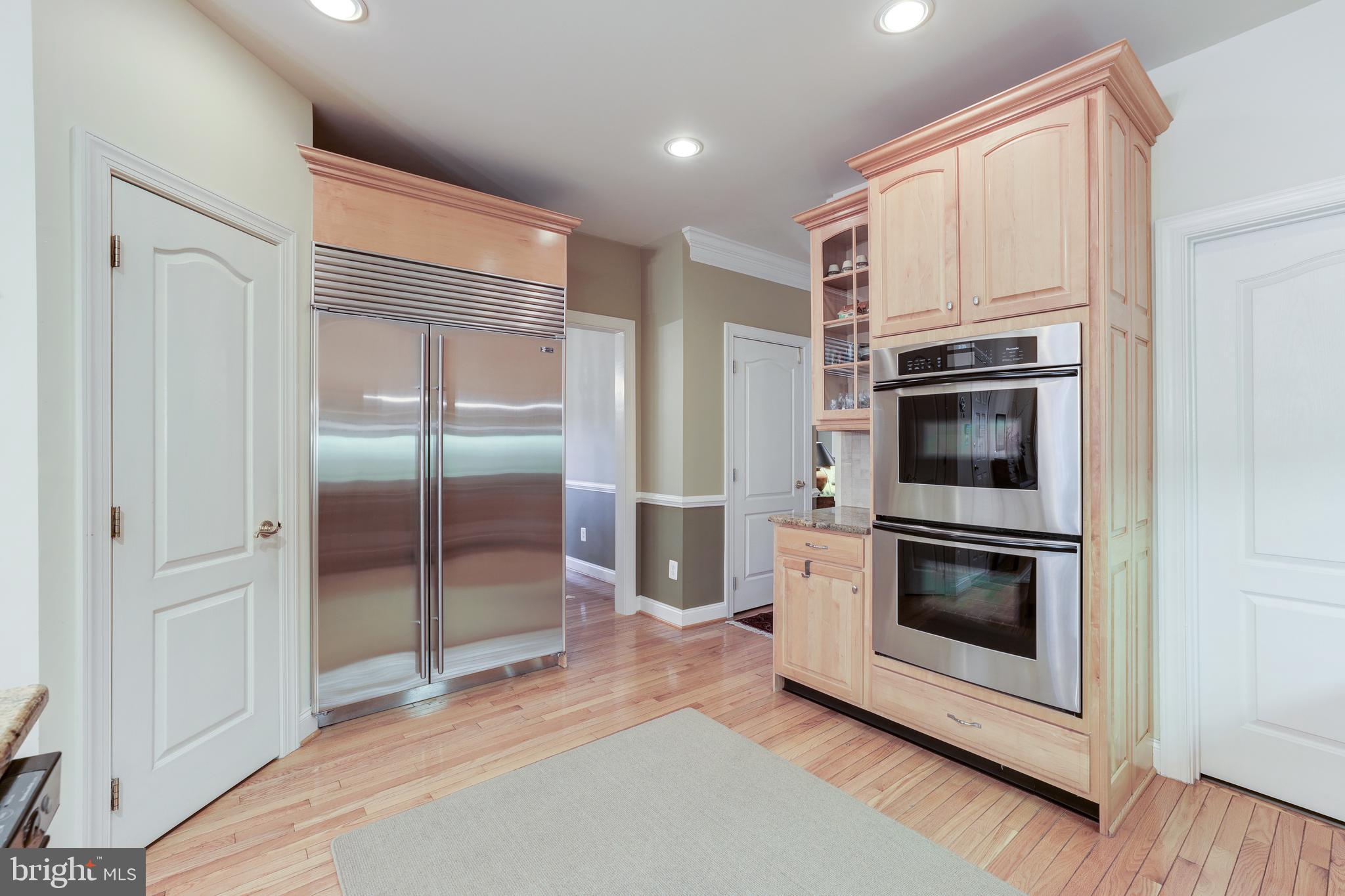 20135 Valhalla Square Ashburn, VA 20147 - Photo 14 of 41 a kitchen with stainless steel appliances a stove a microwave and a refrigerator