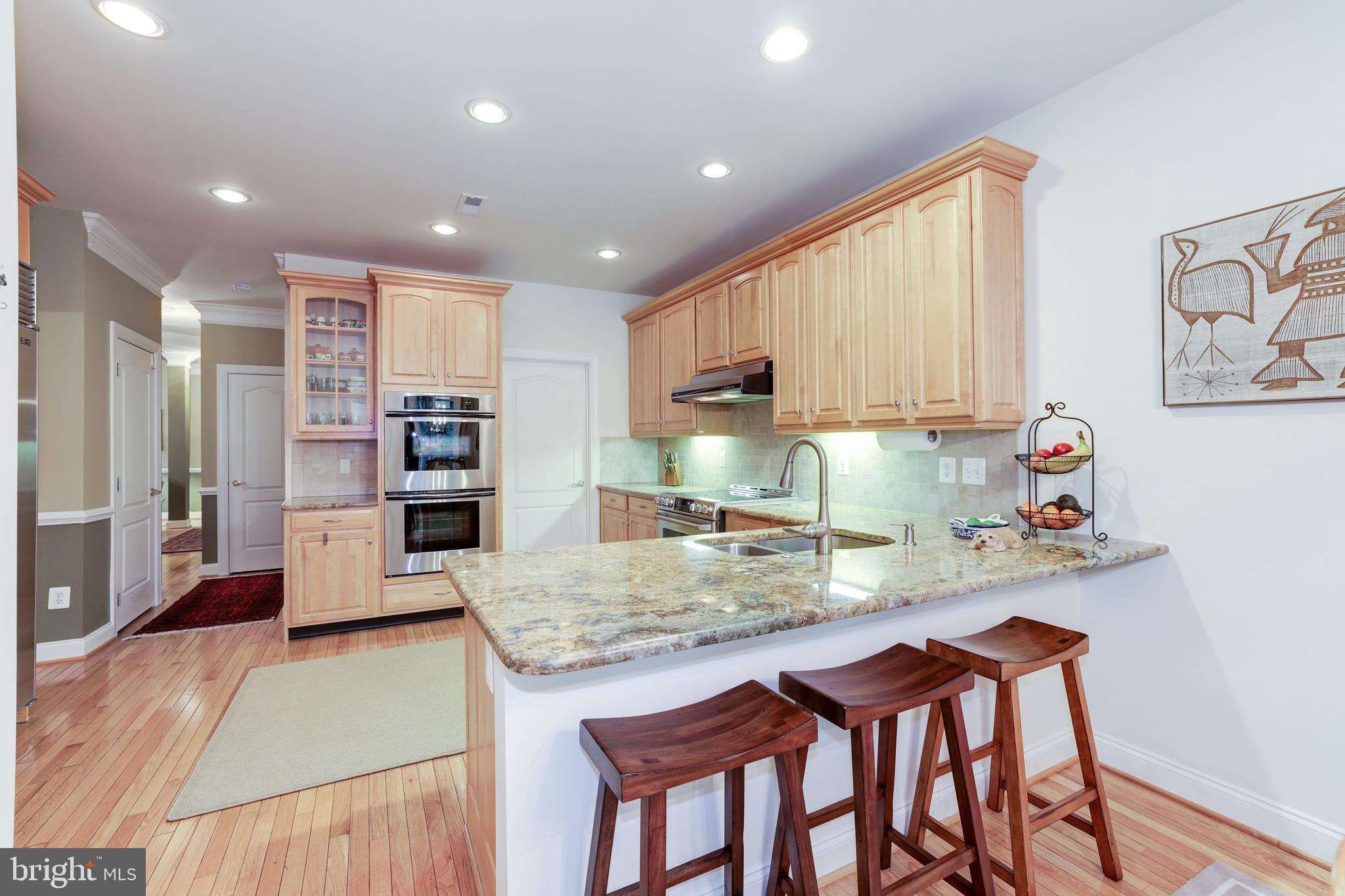 20135 Valhalla Square Ashburn, VA 20147 - Photo 15 of 41 a kitchen with sink and chairs