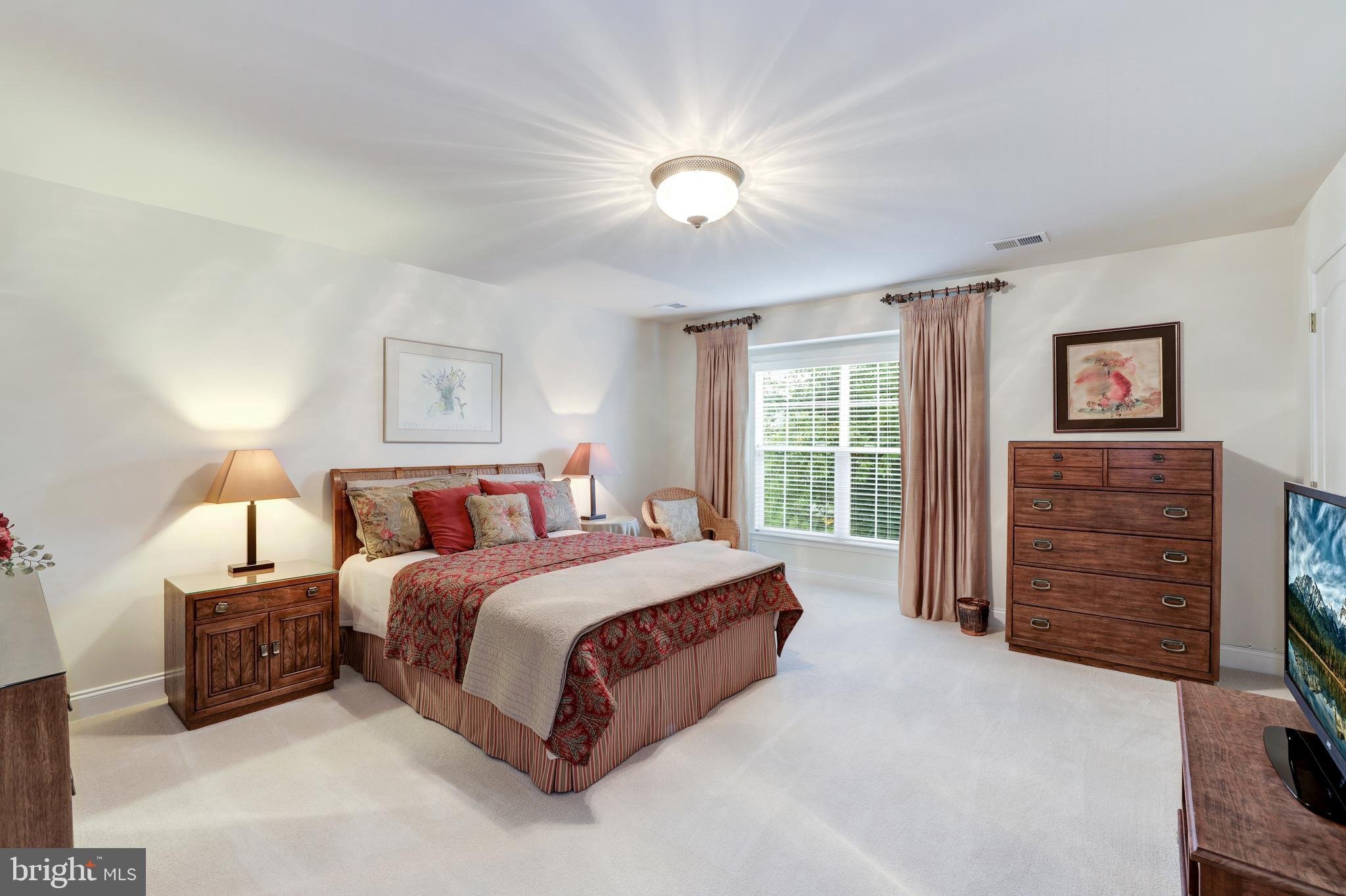 20135 Valhalla Square Ashburn, VA 20147 - Photo 28 of 41 a spacious bedroom with a bed a dresser and a large window