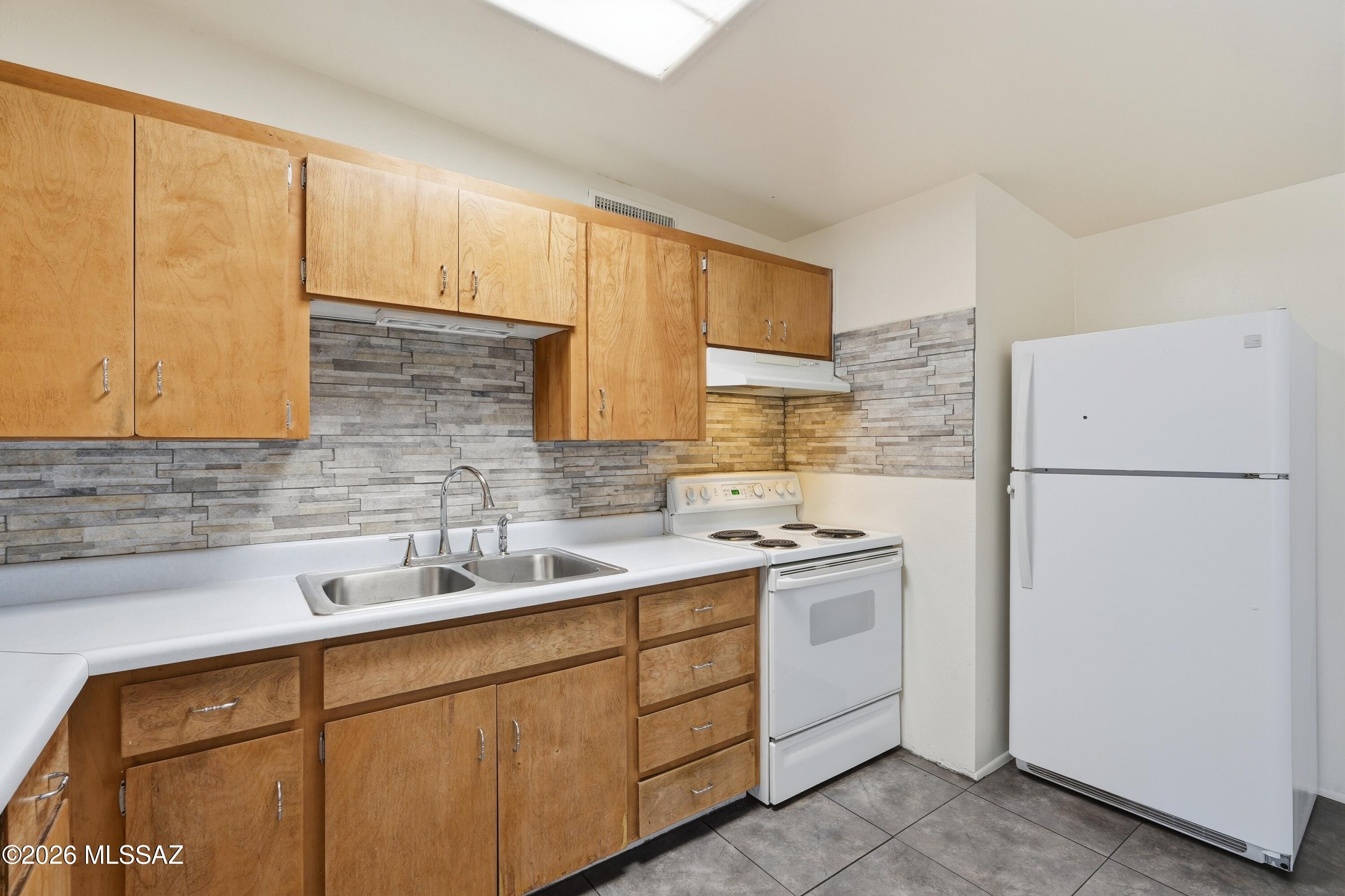 1808 West Caravelle Road Tucson, AZ 85713 - Photo 16 of 38 a kitchen with a sink cabinets and appliances