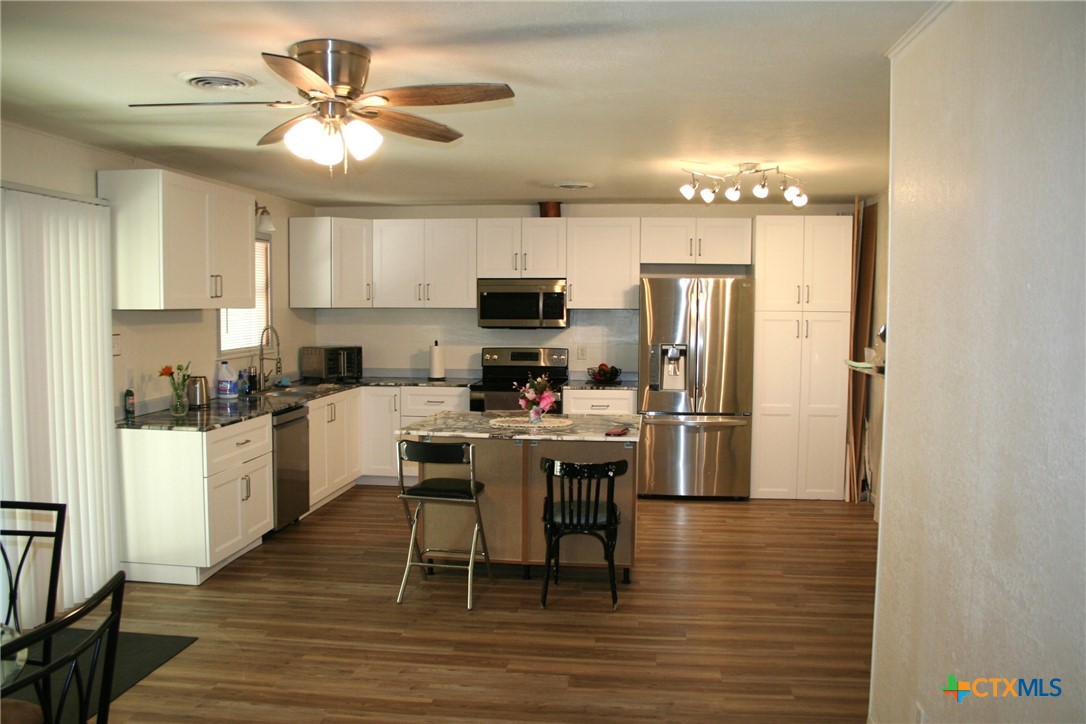 1611 North 10th Street Killeen, TX 76541 - Photo 12 of 31 a kitchen with stainless steel appliances a refrigerator stove microwave and cabinets