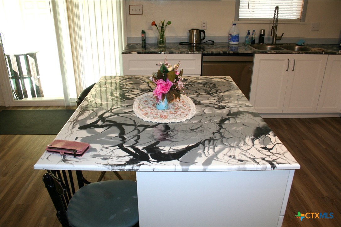 1611 North 10th Street Killeen, TX 76541 - Photo 15 of 31 a view of a kitchen with kitchen island stainless steel appliances a stove a sink and a center island