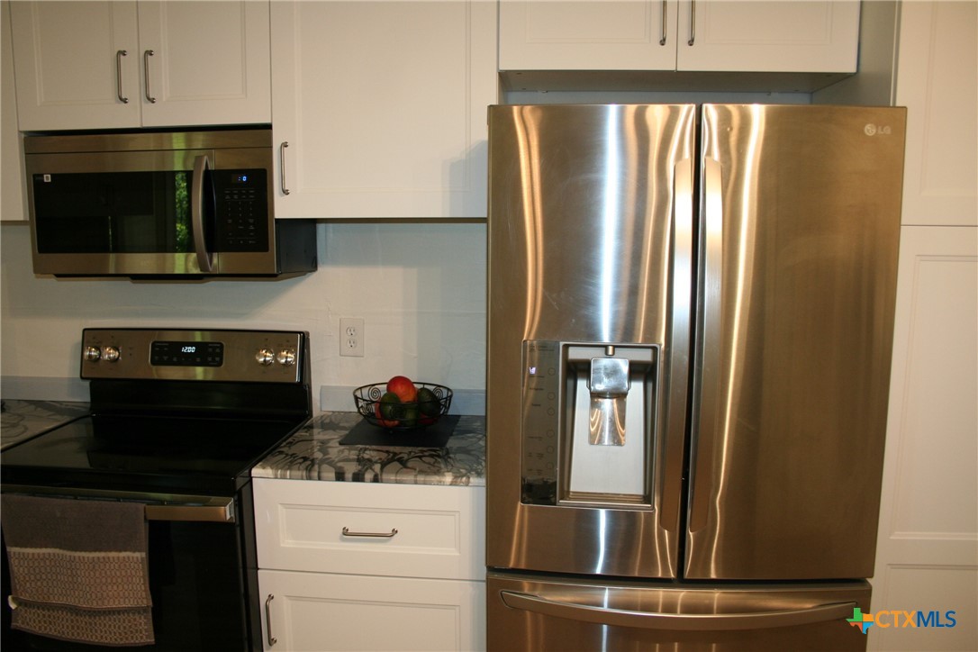 1611 North 10th Street Killeen, TX 76541 - Photo 18 of 31 a kitchen with a refrigerator stove and microwave