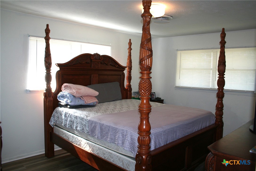 1611 North 10th Street Killeen, TX 76541 - Photo 29 of 31 a bedroom with a bed window and a lamp
