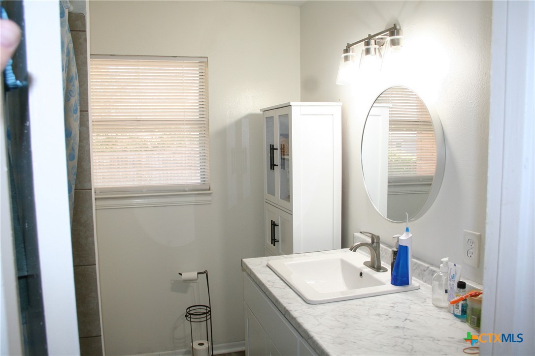 1611 North 10th Street Killeen, TX 76541 - Photo 31 of 31 a bathroom with a sink vanity and a mirror