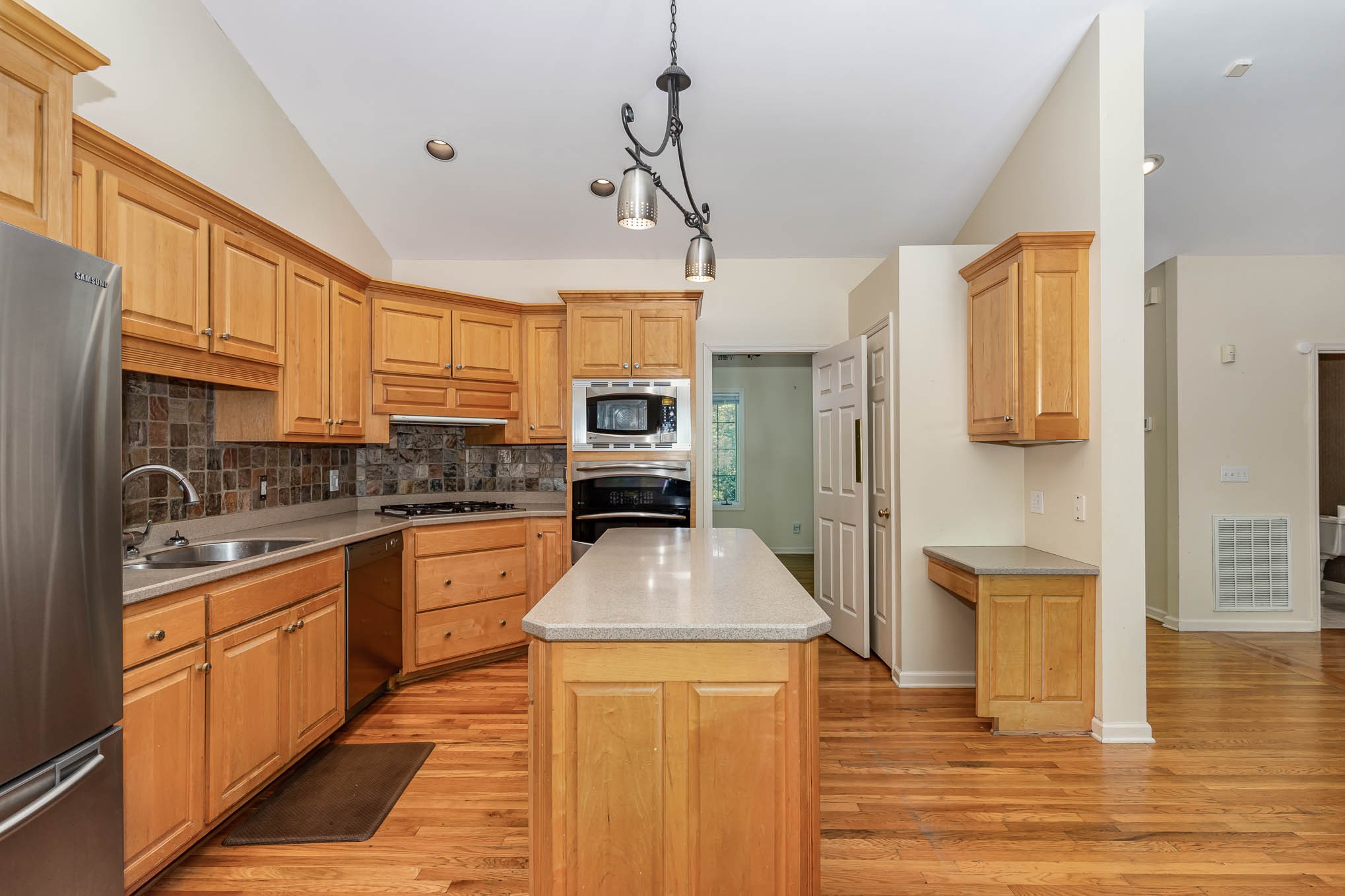 1102 Dora Whitley Road Franklin, TN 37064 - Photo 12 of 42 a kitchen with stainless steel appliances granite countertop a refrigerator a stove top oven a sink dishwasher and white cabinets with wooden floor