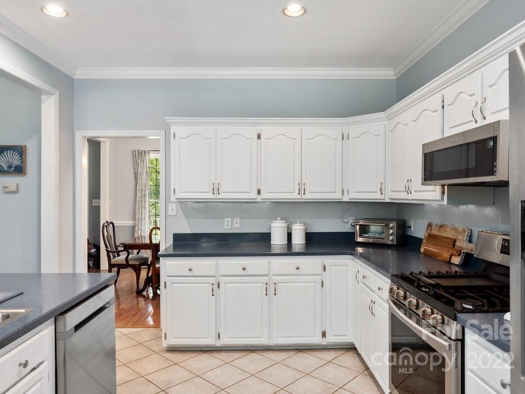 379 Point Carpenter Road Indian Land, SC 29707 - Photo 17 of 47 a kitchen with stainless steel appliances granite countertop a stove a sink and a microwave