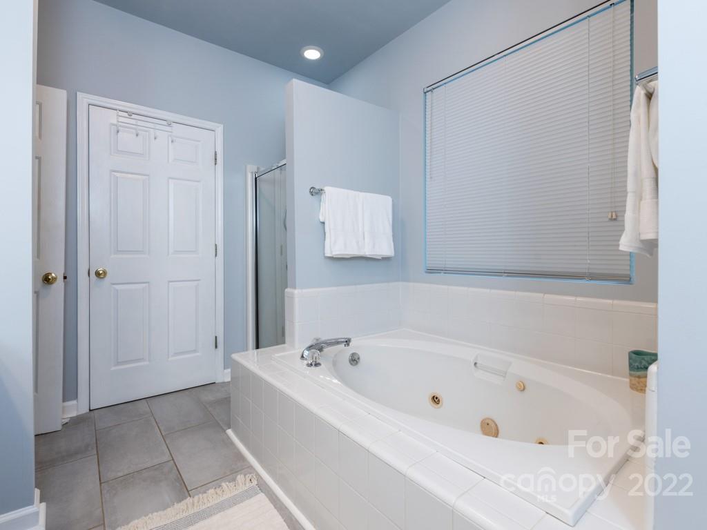 379 Point Carpenter Road Indian Land, SC 29707 - Photo 23 of 47 a white bath tub sitting in a bathroom