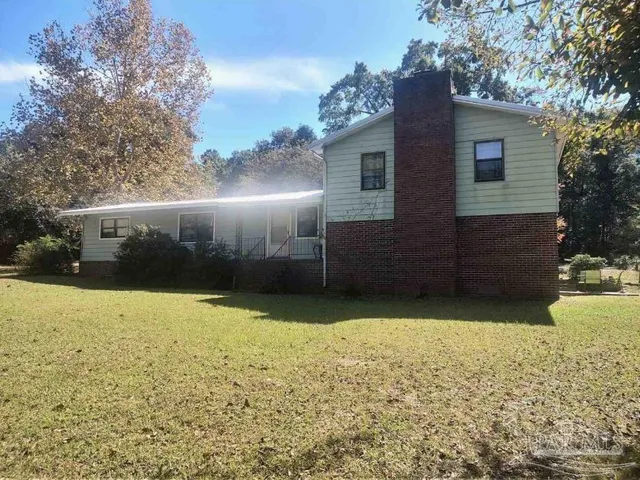 a view of a backyard of the house