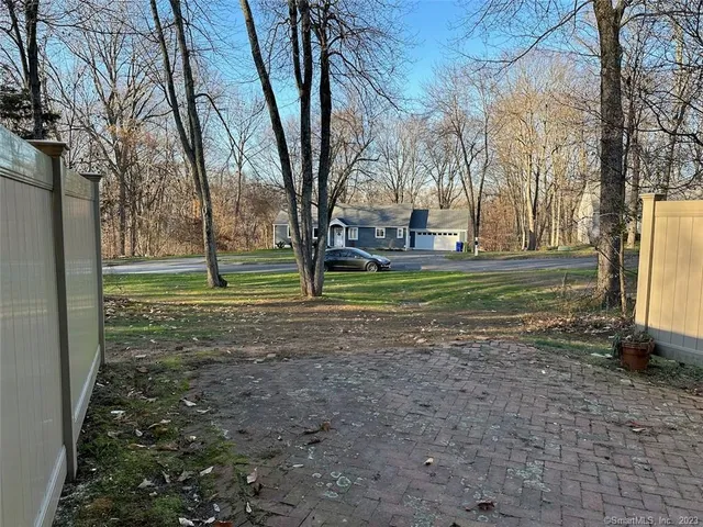a sign broad in front of the red tree