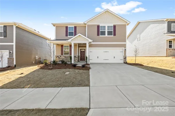 a view of a yard in front view of a house