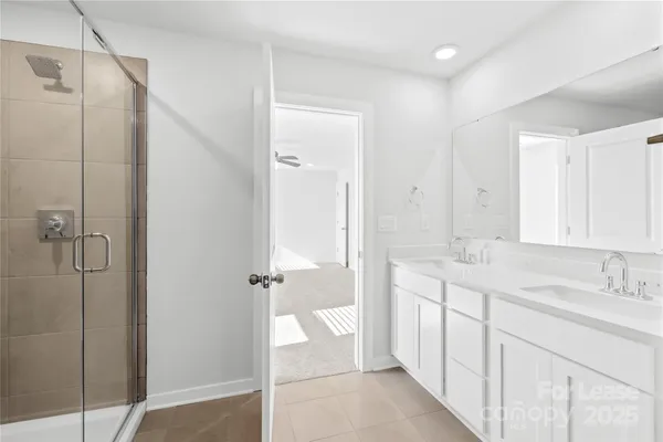 a bathroom with a shower sink and mirror