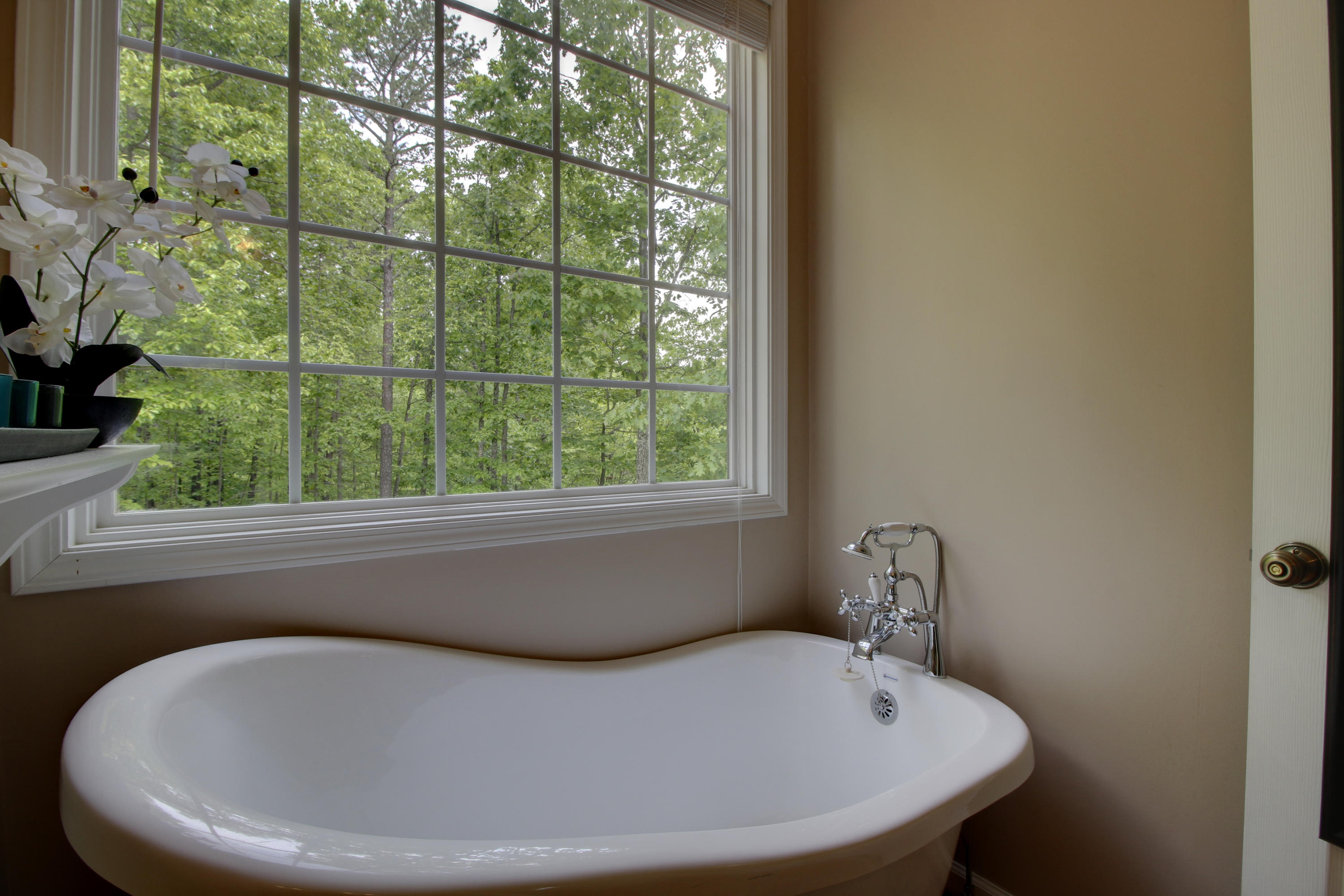 1335 Woodhaven Estates Road Blue Ridge, VA 24064 - Photo 26 of 45 a white bath tub sitting in a bathroom next to a window